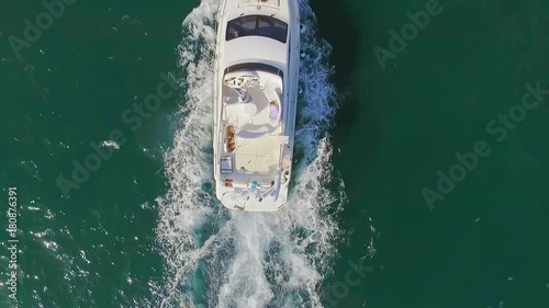 View from copter slowmotion group of young people having fun sailing on luxury yacht over open sea lying on bow enjoying by sunlight