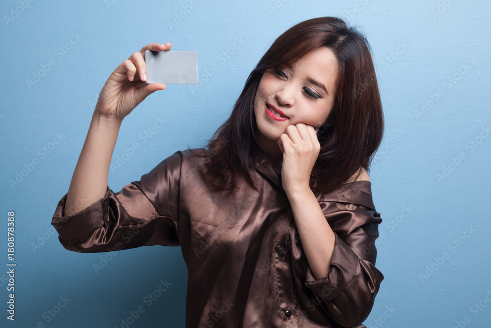 Happy young Asian woman with a blank card. Happy young Asian woman with a blank card.