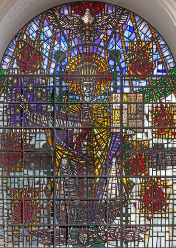 LONDON, GREAT BRITAIN - SEPTEMBER 14, 2017: The Jesus Christ the King on the satined glass in church St. Mary le Bow designed by John David Hayward (1929–2007). photo