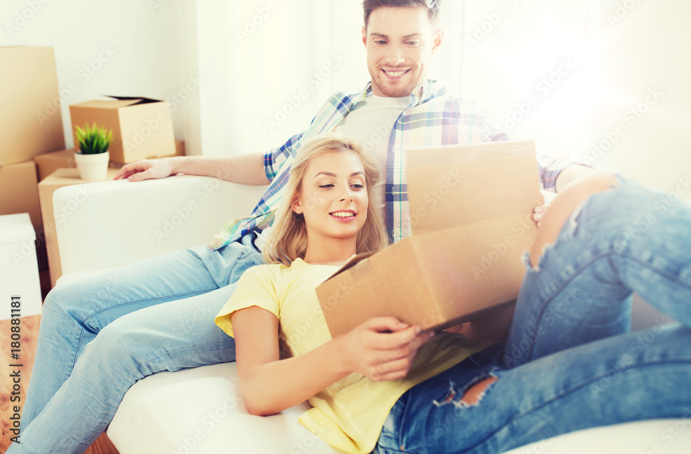 happy couple with big cardboard boxes at new home happy couple with big cardboard boxes at new home
