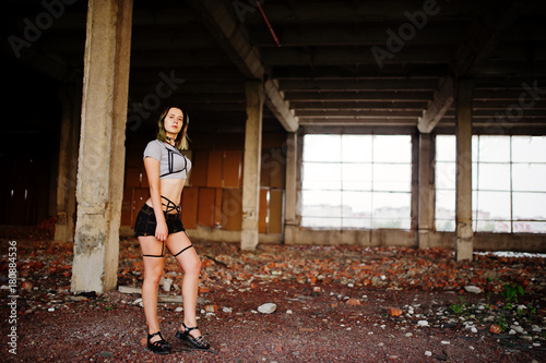Girl wear on shorts and black erotic fetish underwear at abadoned factoty with brick. © AS Photo Family