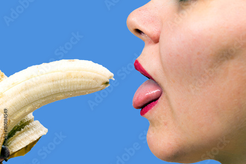 Young woman eating a banana photo