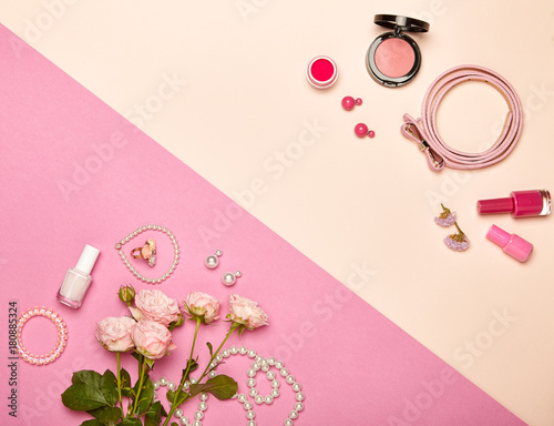 Fashionable Women's Cosmetics and Accessories. Falt Lay. Nail Polish and blush. Jewelry and Rings. A bouquet of flowers. Pink roses photo