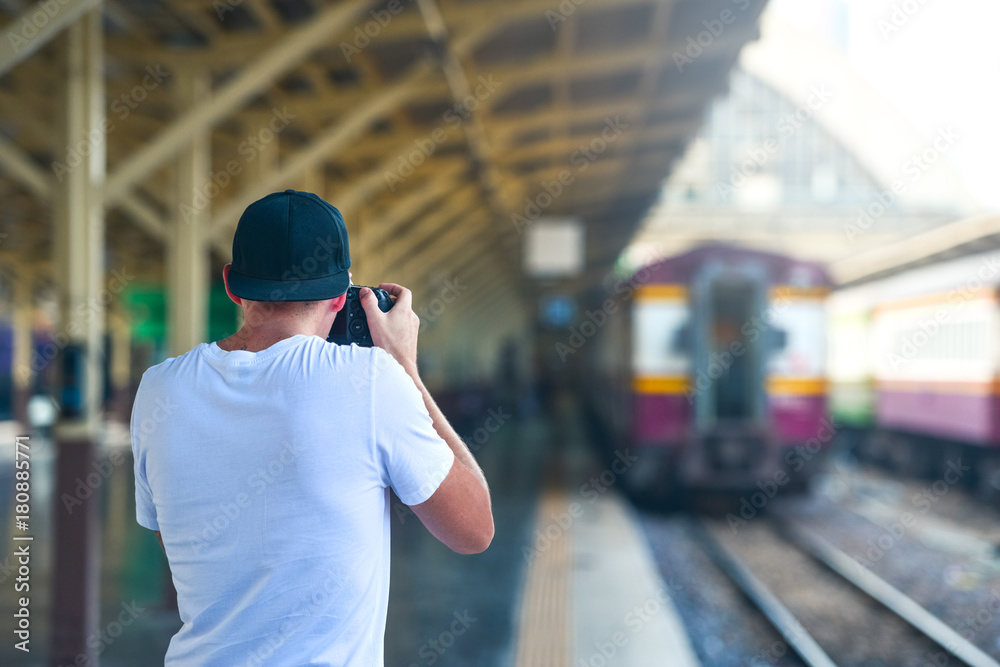 Man take a picture in train station with a camera Man take a picture in train station with a camera