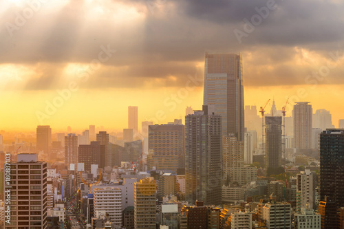 Cityscapes of Tokyo sunset, city aerial skyscraper view of office building and downtown and street of minato in tokyo with yellow sunlight background. Japan, Asia