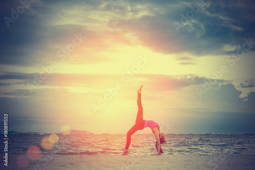 Yoga woman exercise practice at beach of healthy fitness outdoor freedom lifestyle and relax