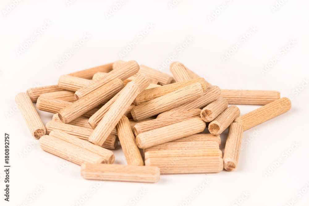 Pile of wooden dowels isolated on white background