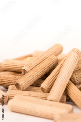 Pile of wooden dowels isolated on white background