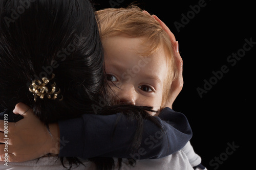 Adoption concept, an orphan is a little boy and his new mother. Happy childhood, caring for children. photo