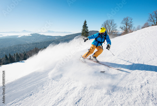 Professional male skier riding the slope on a beautiful winter day copyspace ski resort travelling tourism vacation extreme adrenaline
