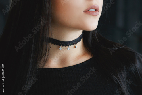 Close up of stylish black choker on female neck