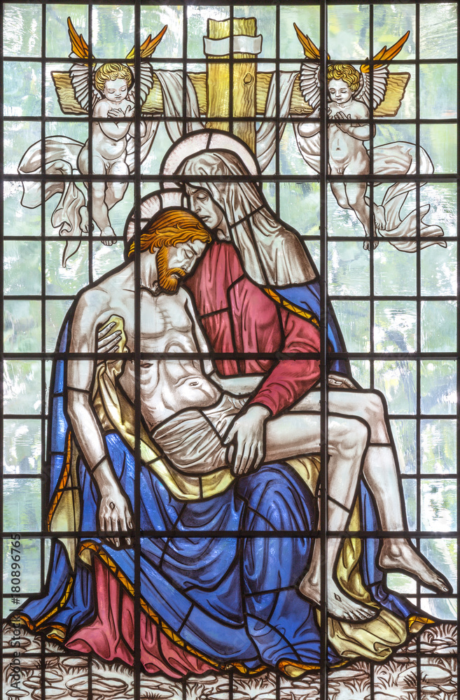 LONDON, GREAT BRITAIN - SEPTEMBER 16, 2017: The Pieta on the stained glass in St Clement Danes from 20. cent.