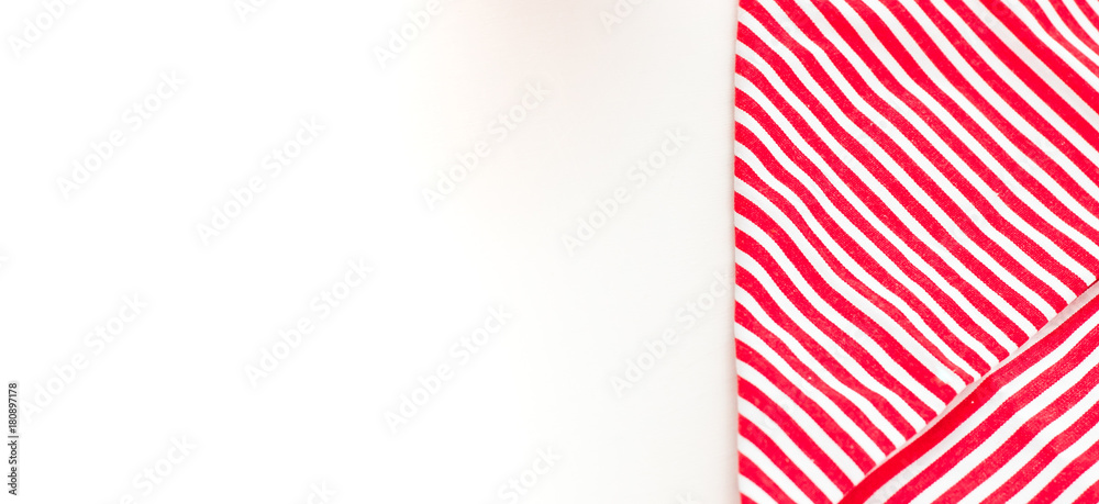 Fototapeta premium Red textile, napkin, tablecloth on wooden kitchen table. View from above, top with copy space. Traditional pattern and color.