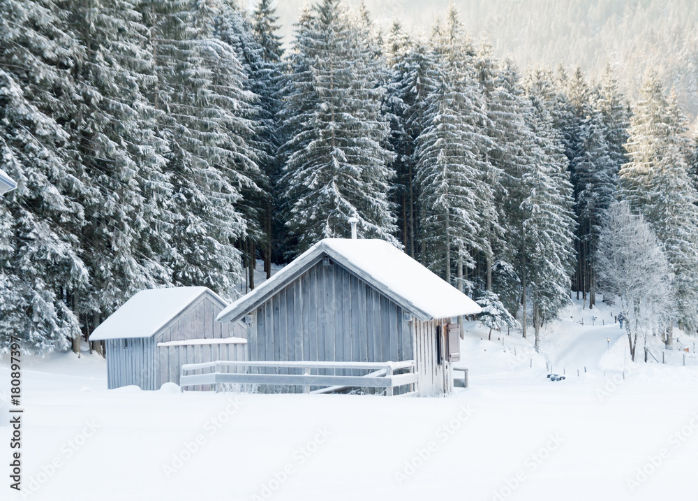 wood hut in winter snow landscape