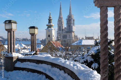 View over Zagreb during winter with snow with view to towers of church and cathedral and seating area with laternsat a sunny day, Zagreb, Croatia, Europe photo