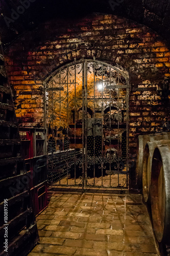 Wine bottles and barrels stored in a Hungarian wine cellar