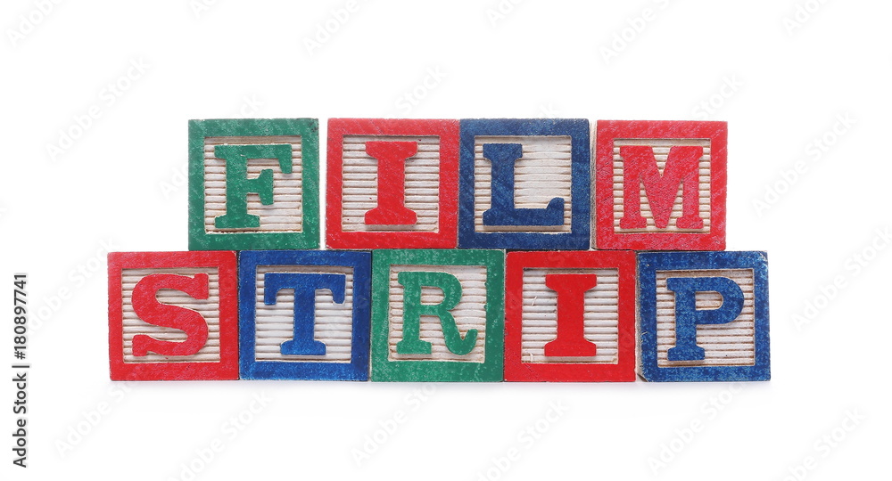 Wooden alphabet blocks spelling out film strip isolated on white background
