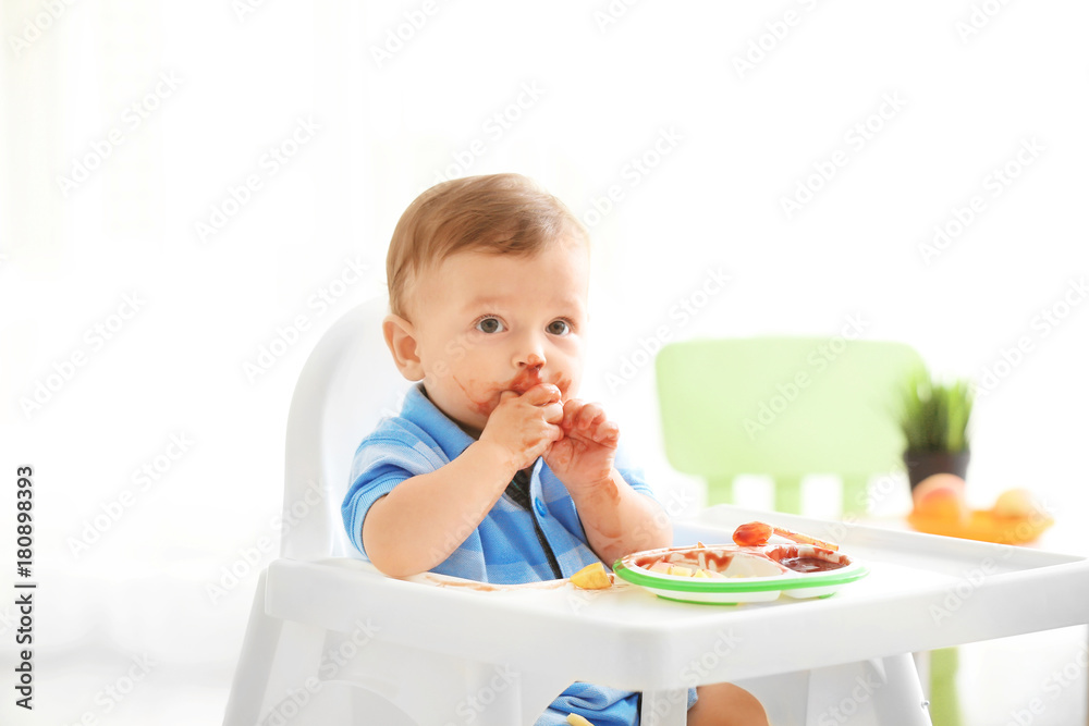 Cute messy baby eating puree at home Cute messy baby eating puree at home