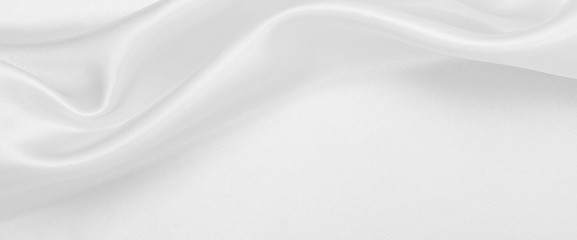 Smooth elegant white silk or satin luxury cloth texture as wedding background. Luxurious background design