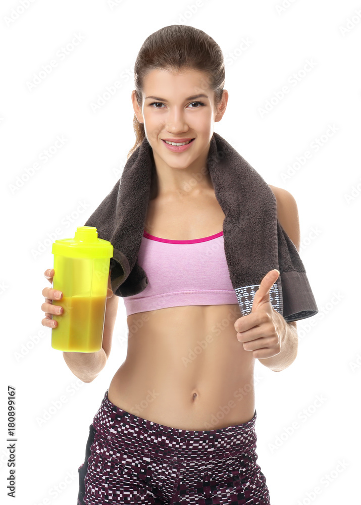 Beautiful young woman with protein shake showing thumb up gesture on white background Beautiful young woman with protein shake showing thumb up gesture on white background