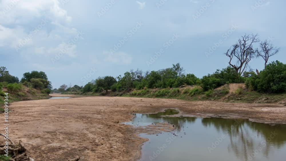 A static timelapse of the Limpopo River bordering South Africa and Botswana showing dry conditions with stormy clouds building up and a puddle of water. A static timelapse of the Limpopo River bordering South Africa and Botswana showing dry conditions with stormy clouds building up and a puddle of water.