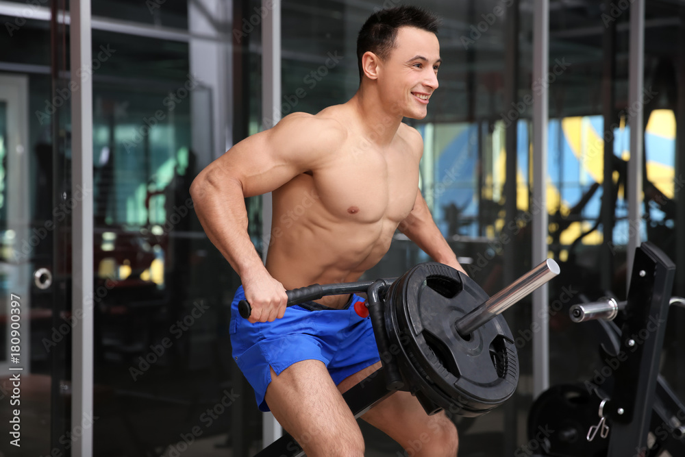 Muscular man training in gym