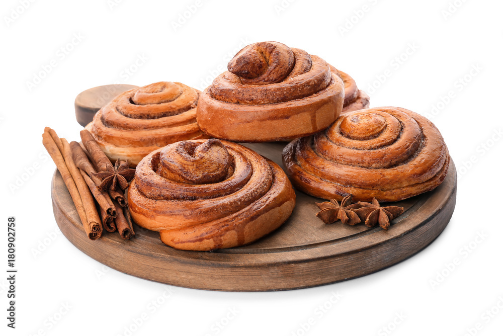 Wooden board with sweet cinnamon rolls on white background