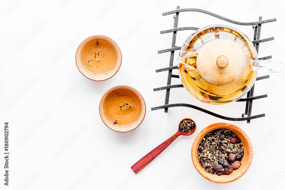 Tea ceremony concept. Tea pot, cups or bowls, dry tea leaves on white background top view Tea ceremony concept. Tea pot, cups or bowls, dry tea leaves on white background top view