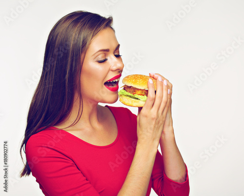 Woman eating burger. Isolated portrait on white