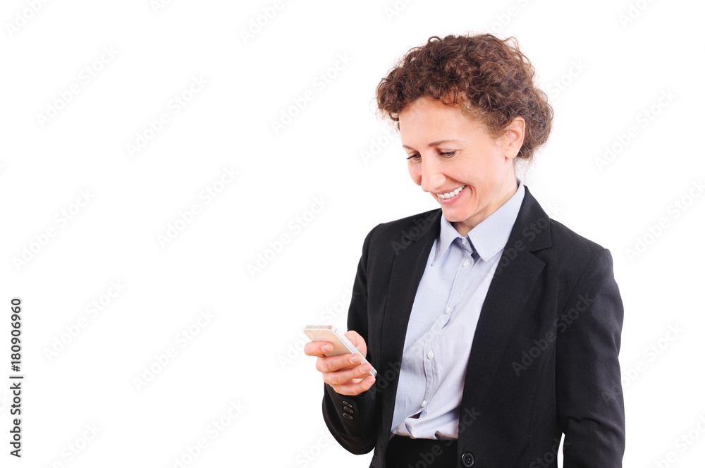 Smiling business woman in suit holding smartphone and looking on it Smiling business woman in suit holding smartphone and looking on it