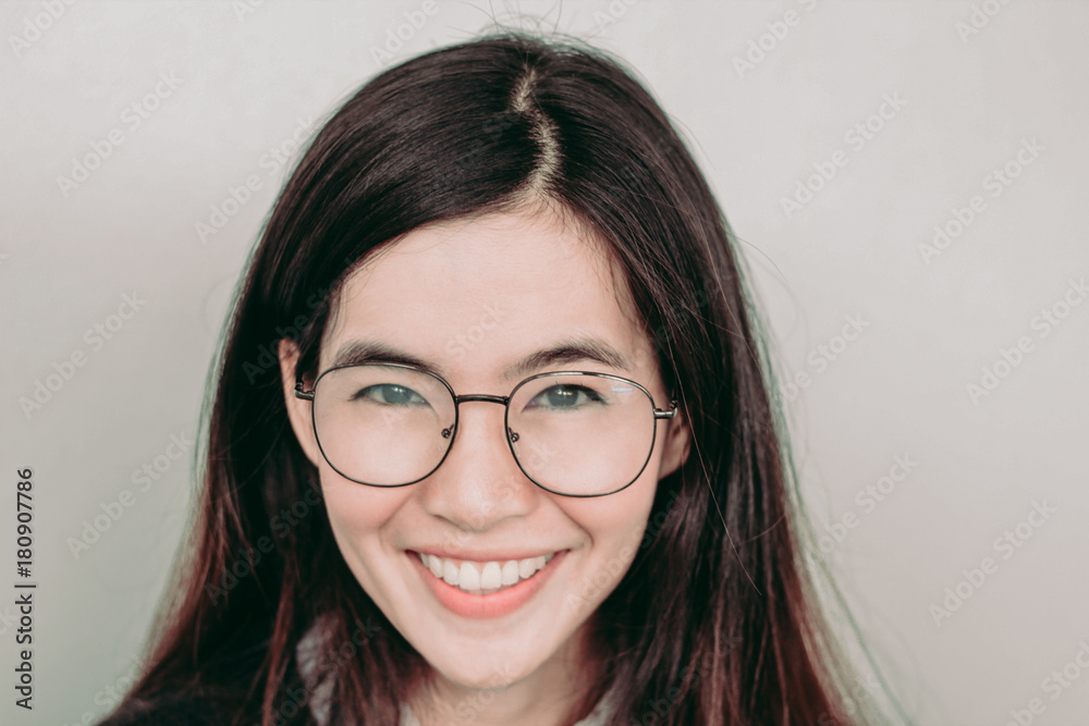 Head shot of Young cute asian student wearing glasses and smiling