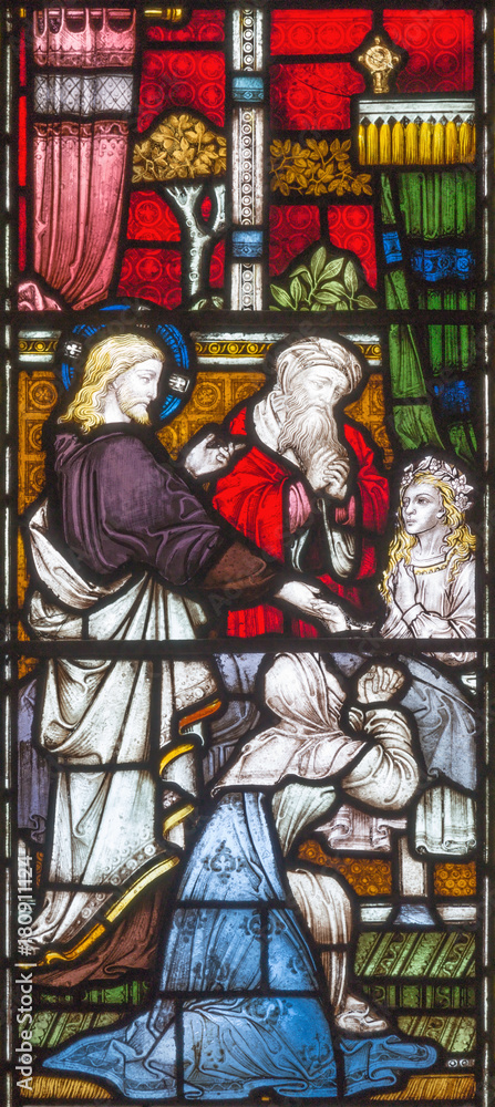 LONDON, GREAT BRITAIN - SEPTEMBER 19, 2017: The Raising of Jairus Daughter on the stained glass in St Mary Abbot's church on Kensington High Street.