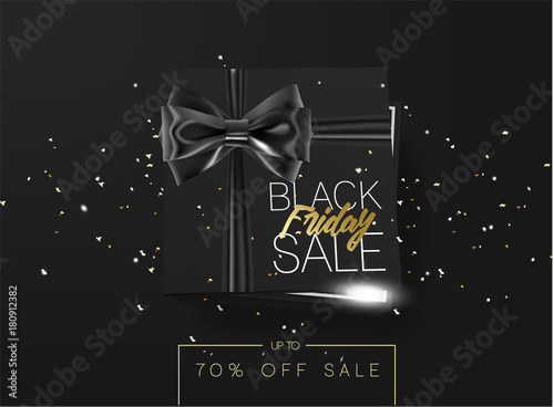 Black friday sale cardboard box tied with a black ribbon bow and lying on a black background with confetti and inscription Black friday Top view Template for the poster, banner and web photo