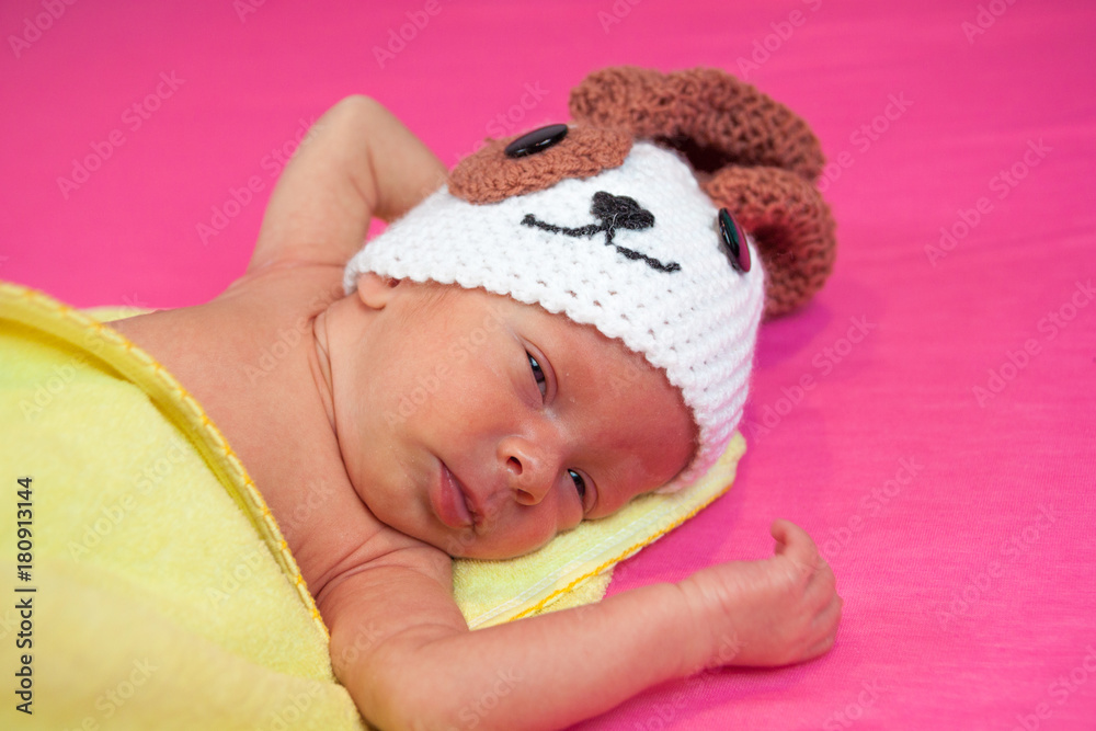 cute newborn baby sleeps in a knitted hat dogs cute newborn baby sleeps in a knitted hat dogs