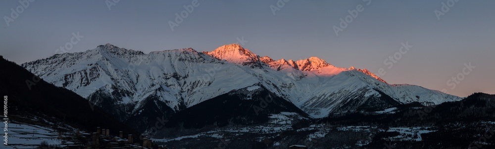 Panorama of snow mountain in winter time, sunset.