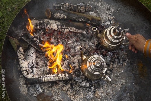 A traditional way of making Maroccan mint tea on an open fire