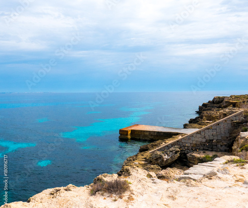 The iron dock over the turquoise Mediterranean sea. - Island of Favignana, Trapani, Sicily, Italy
