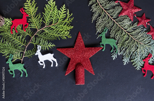 Pine Branches with Christmas Deers and Red Star on a Black Background.Christmas Card
