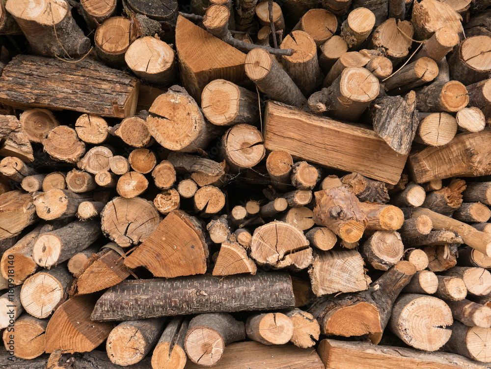 Pieces of different size are forming this wood pile of chopped pieces of pine, oak and others, ready to be burned into fireplace during winter time. Pieces of different size are forming this wood pile of chopped pieces of pine, oak and others, ready to be burned into fireplace during winter time.