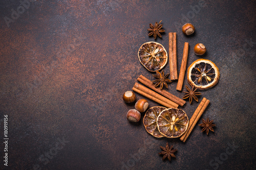 Christmas spices and  nuts on rusty stone table. Top view.