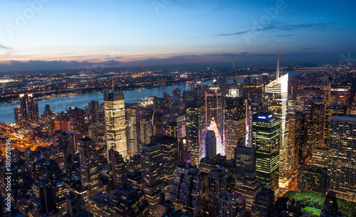 Aerial view of Manhattan New York skyline at sunset  during the blue hours  with lights of skyscrapers turning on.