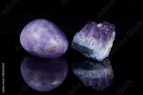 Treated amethyst and mountain crystal on a dark background with reflection