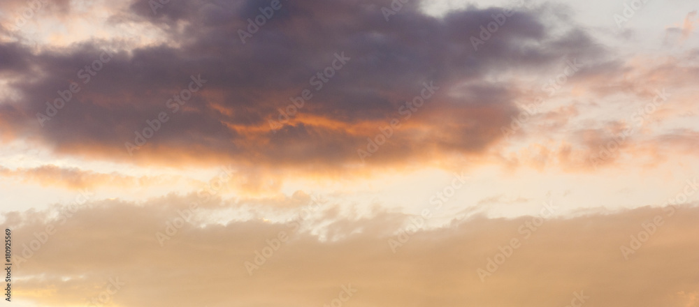 The panorama of the sky with couds at the sunset. Copy space