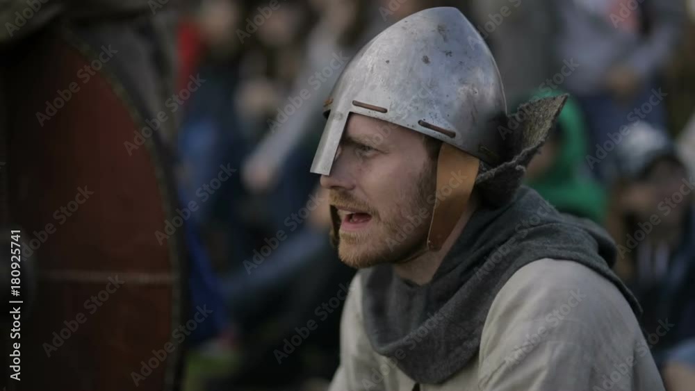 Man in a helmet sits on the ground and nods his head close up Man in a helmet sits on the ground and nods his head close up