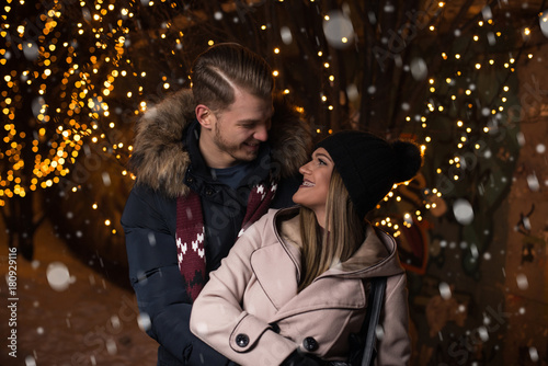 Happy Couple Holding Hands at Christmas Market