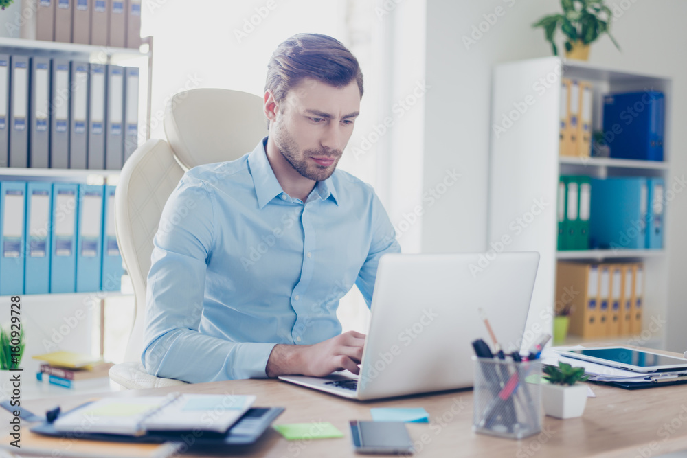 Minded confused boss is using the computer, typing to his colleagues and tying to find the way out from his problem at work Minded confused boss is using the computer, typing to his colleagues and tying to find the way out from his problem at work