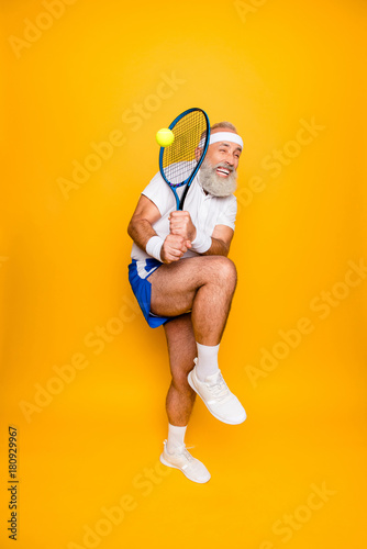 Body care, hobby, weight loss, game process. Competetive emotional cool grandpa with humor grimace exercising holding equipment, swatting ball with strength and power scared © deagreez