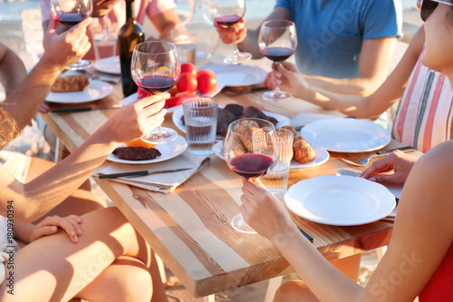 Young people having barbecue party at table