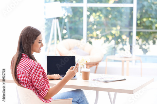 Young woman with laptop and...