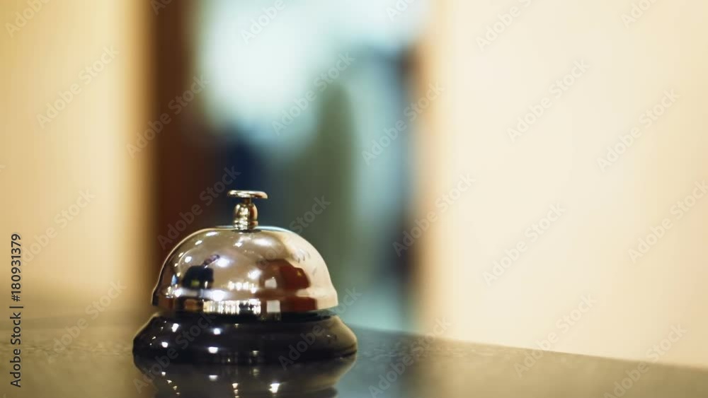 close up view male person man hand ring bell finger ringing hotel reception desk modern interior table blurred background service elegant receptionist hostel business lobby hall room reservation